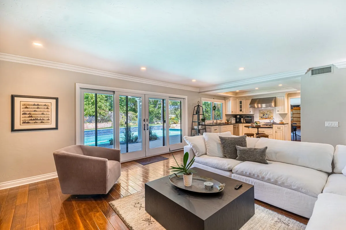 Open-plan living room with a wall of glass doors looking out to a patio