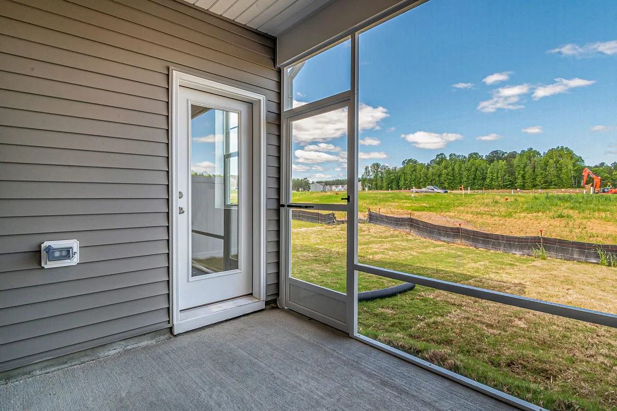 Glazed door and large windows opening onto a patio and lawn